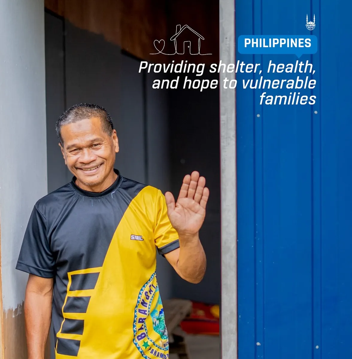 Man waving outside a shelter in the Philippines