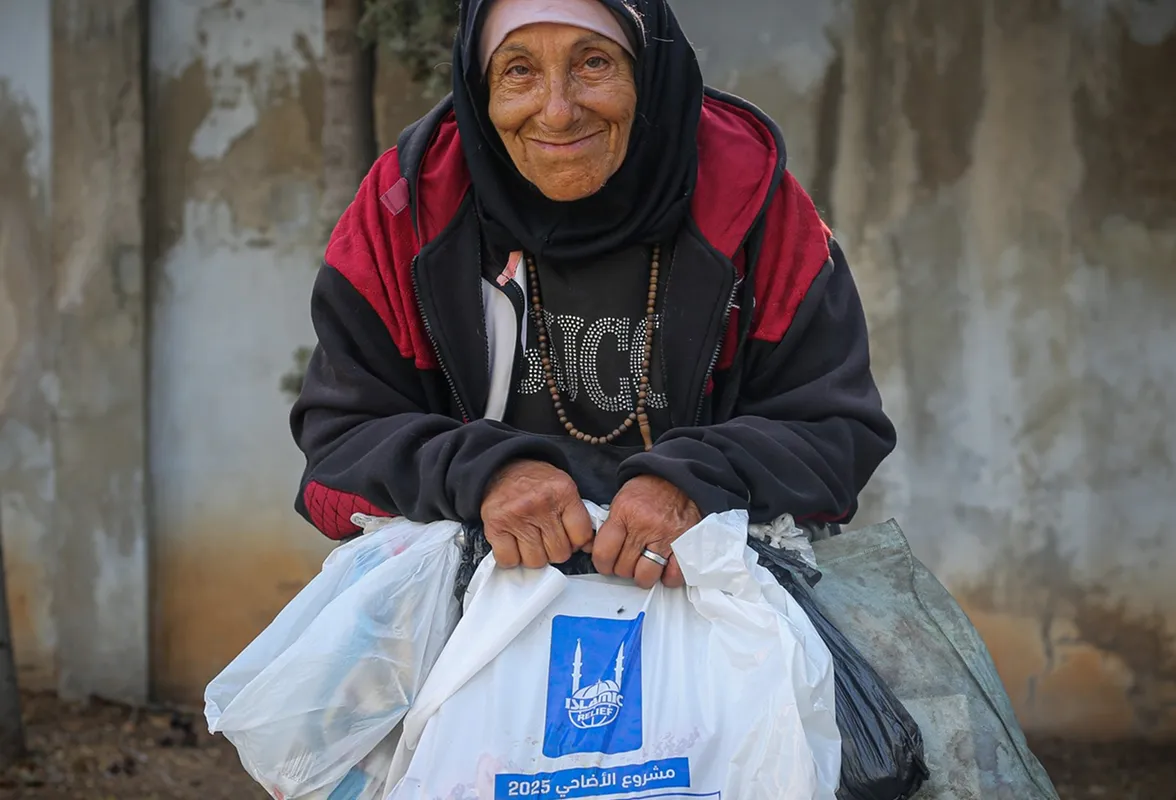 Man waving outside a shelter in the Philippines